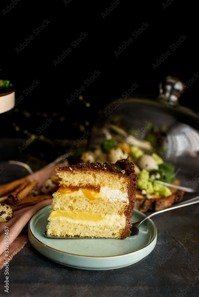 Delicious cake in the cut, a piece of cake with a layer of mango, passion fruit, vanilla cream, biscuit. Delicious cake in the cut, a piece of cake with a layer of mango, passion fruit, vanilla cream, biscuit.