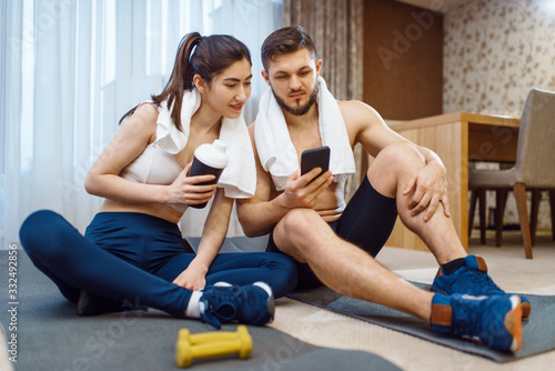 Love couple resting after fitness workout at home