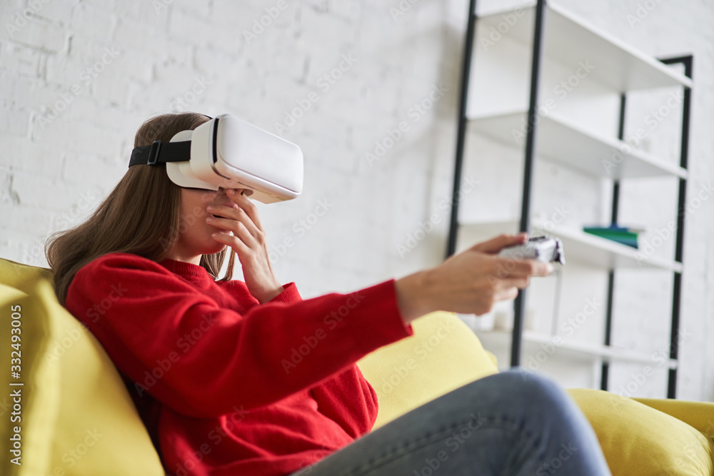 Portrait of amazed excited woman gaming virtual reality glasses with open mouth expression Portrait of amazed excited woman gaming virtual reality glasses with open mouth expression