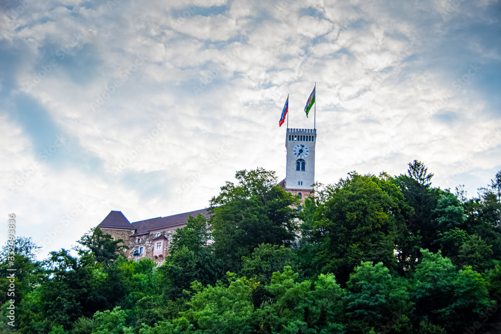Flag of Slovenia and City of Ljubljana waving over the Ljubljana castle tower