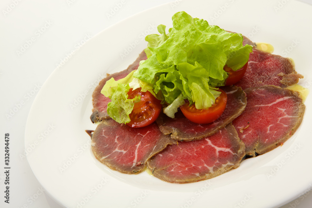 Assortment of cold meats and sausage isolated on white background
