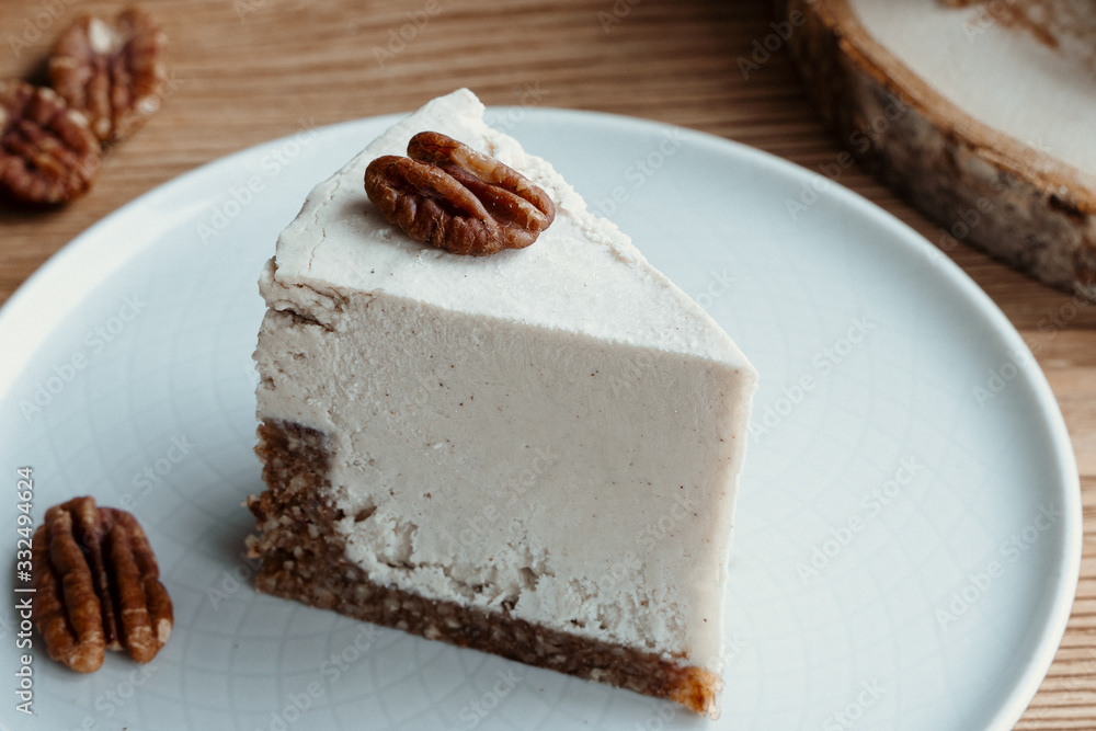  cake with cream. Pecan cake on a wooden background. Raw dessert. Food photography