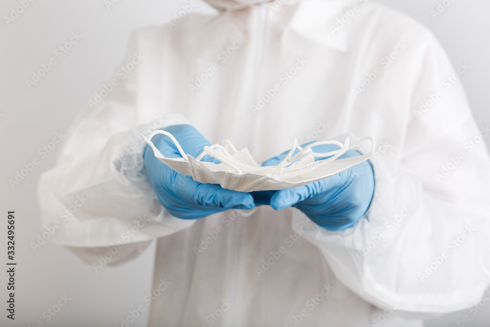 Doctor's hand with some medical face mask for protection against infection Doctor's hand with some medical face mask for protection against infection