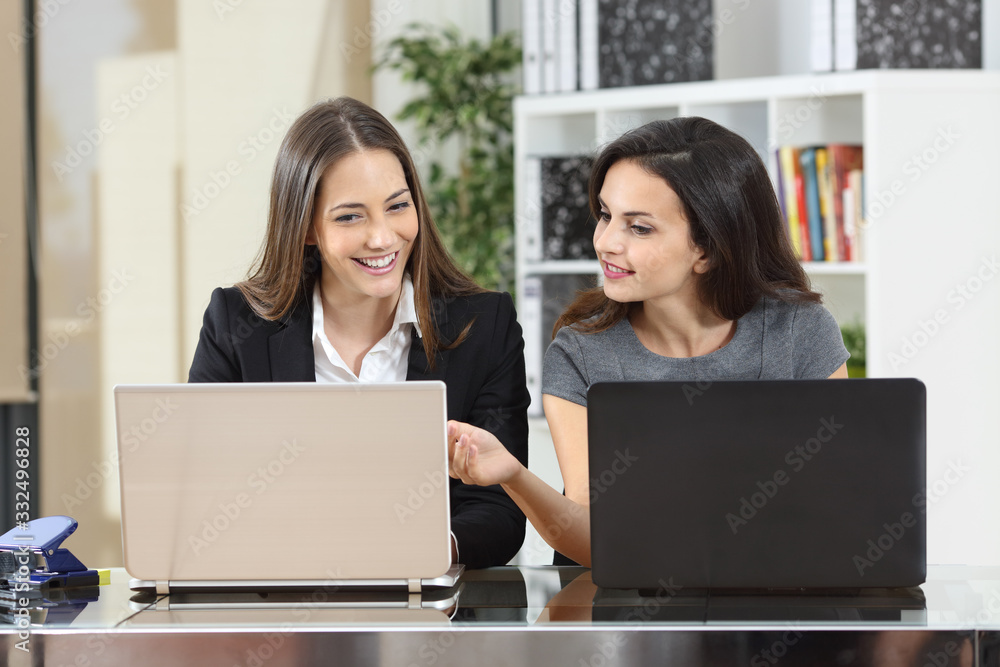 Businesswoman helping to her colleague at office Businesswoman helping to her colleague at office