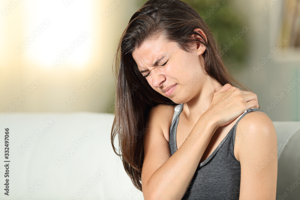 Girl complaining suffering shoulder ache at home Girl complaining suffering shoulder ache at home