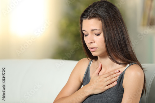 Girl having respiration problems touching chest