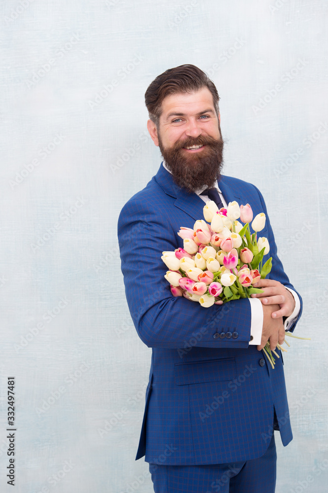Waiting for his girlfriend. man in jacket holding bouquet of flowers. tulips for womens day. happy birthday concept. stay romantic at any season. man presenting flowers. mothers day Waiting for his girlfriend. man in jacket holding bouquet of flowers. tulips for womens day. happy birthday concept. stay romantic at any season. man presenting flowers. mothers day