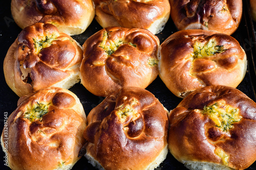 Freshly homemade cheese and dill buns, on display for sale at a street food market,top view or flat lay photo of healthy food photographed with selective focus