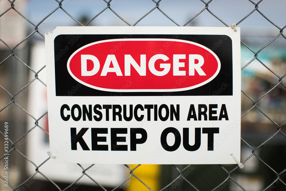 Danger Construction area Keep out sign on metal chain link fence Danger Construction area Keep out sign on metal chain link fence