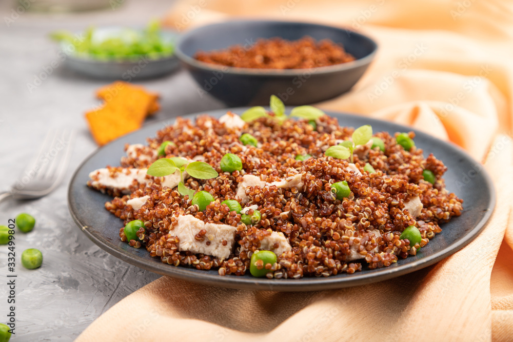 Quinoa porridge with green pea and chicken on ceramic plate on a gray concrete background. Side view, selective focus. Quinoa porridge with green pea and chicken on ceramic plate on a gray concrete background. Side view, selective focus.