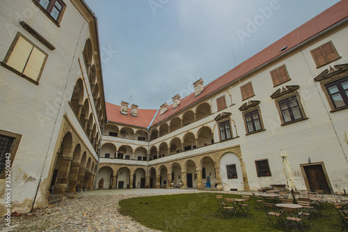 Beautiful courtyard with arches of the Ptuj castle. Facade and main square of Ptujski grad on a dull autumn day. © Anze