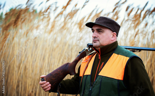 Hunter with a rifle in hunting