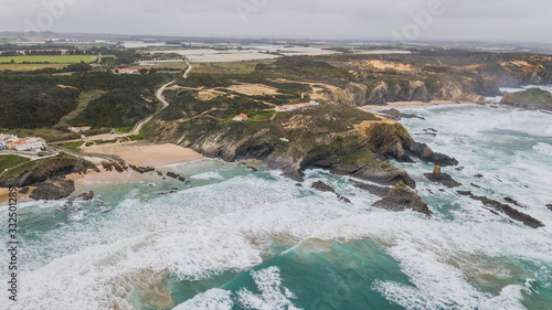 Beachs at the foot of a cliff. Zambujeira do Mar and Alteirinhos beach, Zambujeira do Mar, Portugal photo
