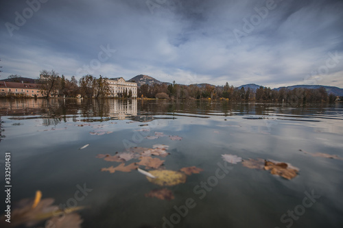 Cold autumn panorama of Schloss Leopoldskron and the Leopoldskroner Weiher in Salzburg, Austria. Beautiful hotel where the sound of music was filmed rising just out of the water. photo