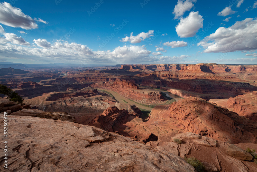 Clouds billow as the Colorado River flows around the bend of Dead Horse Point in Utah