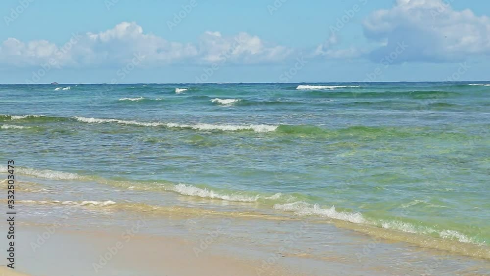 white fluffy clouds flow above blue ocean with many waves white fluffy clouds flow above blue ocean with many waves