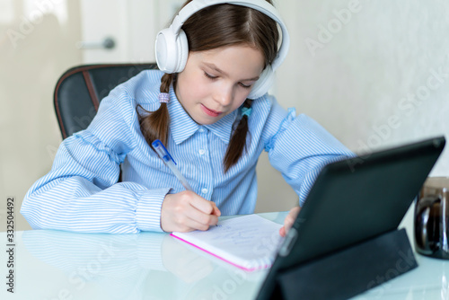 Young girl learn by tablet at home. Distance learning in quarantine. Isolation photo