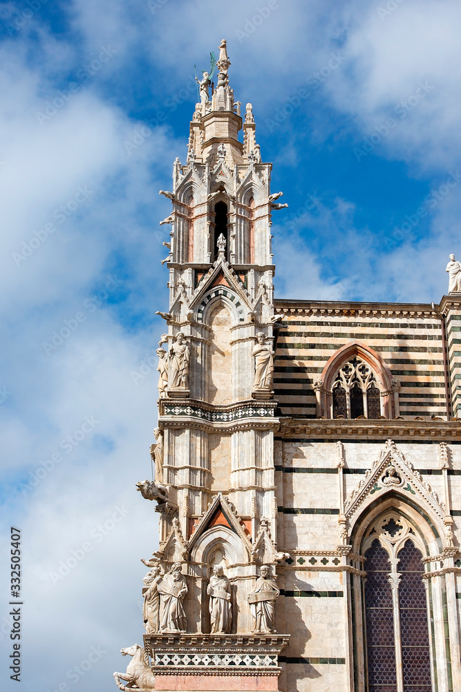 gargoyles and saints on facade of Siena Cathedral (Duomo di Siena) is a medieval church, now dedicated to the Assumption of Mary, completed between 1215 and 1263, Siena, Italy