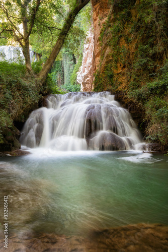 Fototapeta Naklejka Na Ścianę i Meble -  Idyllic Waterfall in rainforest landscape. Water flowing in tranquil scenery .