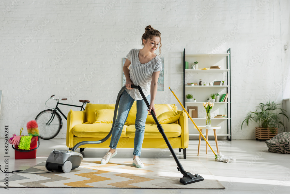 happy girl cleaning carpet with vacuum cleaner Stock Photo | Adobe Stock