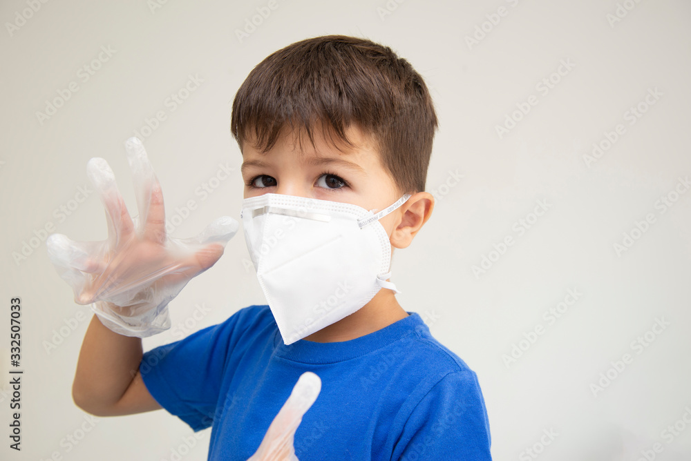 Caucasian boy wearing mask and surgical gloves with gesturing with his hands protecting himself from respiratory diseases. Face mask to protect against outbreaks of coronavirus, covid-19, virus, disea