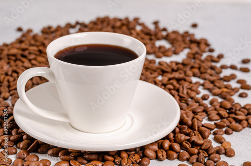 Coffee in a cup with coffee grains