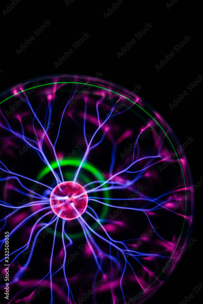 Lightning center with pink green purple light streams in round electrical glass lamp in dark Lightning center with pink green purple light streams in round electrical glass lamp in dark
