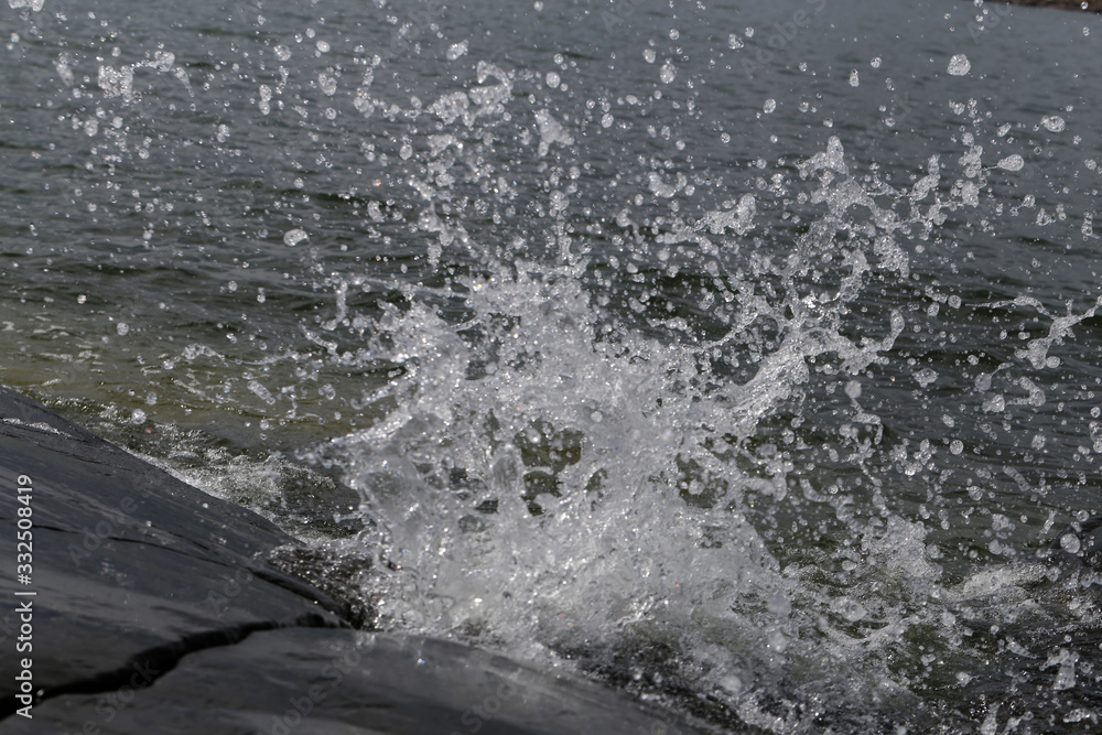Waves hitting rocks in Helsinki, Finland. Beautiful photo representing the power and strength of the sea during windy weather. Waves can be dangerous but they also create beautiful splashes. Waves hitting rocks in Helsinki, Finland. Beautiful photo representing the power and strength of the sea during windy weather. Waves can be dangerous but they also create beautiful splashes.