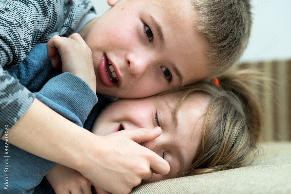 Two children boy and girl fooling around having fun together. Happy childhood concept.