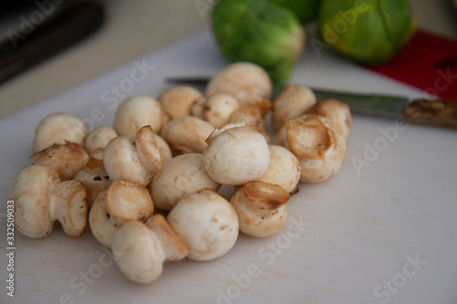 Mushrooms with Brussel Sprouts in Background Cutting Board in Kitchen - Food Prep