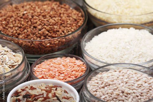 A set of bowls filled with different seeds: buckwheat, rise, corn and oatmeal	