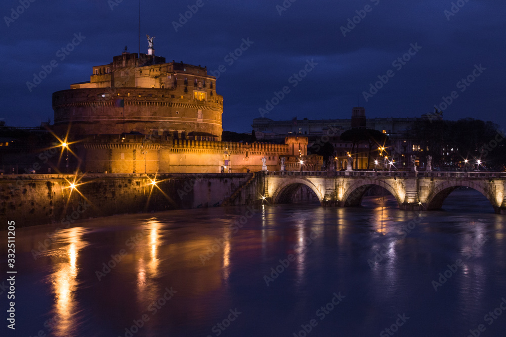 Long exposure in Sant Angelo Castle, Sant Angelo bridge and river Tiber at night with light set, Rome, Italy. Top view.