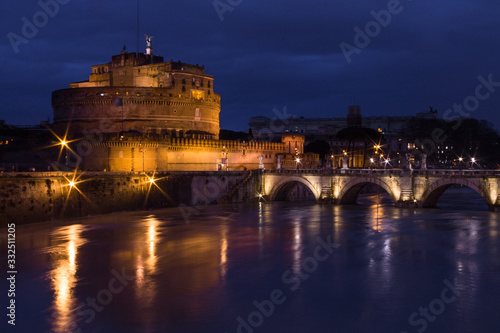 Long exposure in Sant Angelo Castle, Sant Angelo bridge and river Tiber at night with light set, Rome, Italy. Top view.