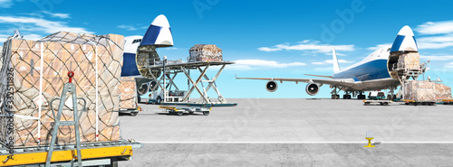 loading cargo airplane on airport runway ultra wide panorama landscape with freight containers and shipping packages on foreground against blue clouds sky background Airport overview with cargo planes © vaalaa