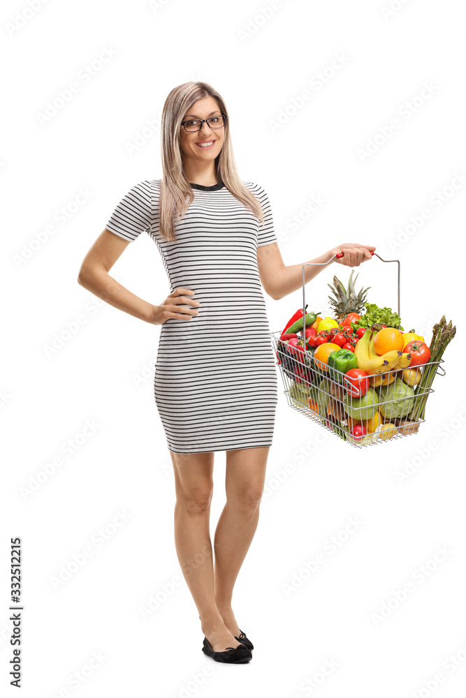 Young woman holding a shopping basket with fresh frits and vegetables Young woman holding a shopping basket with fresh frits and vegetables