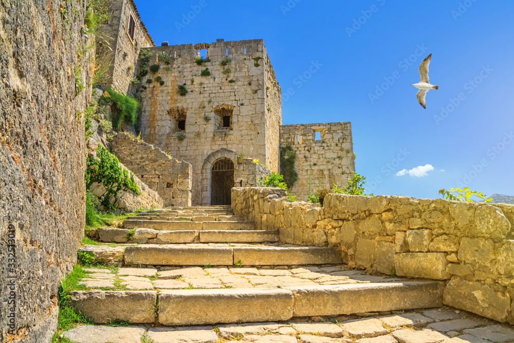 Summer mediterranean landscape - view of the stairs in the Klis Fortress, near Split on the Adriatic coast of Croatia