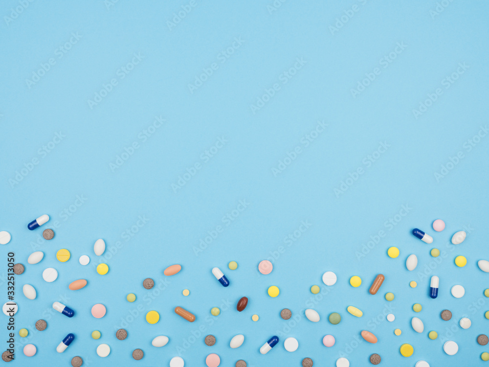 Spilled pills on a blue background. Spilled pills on a blue background.