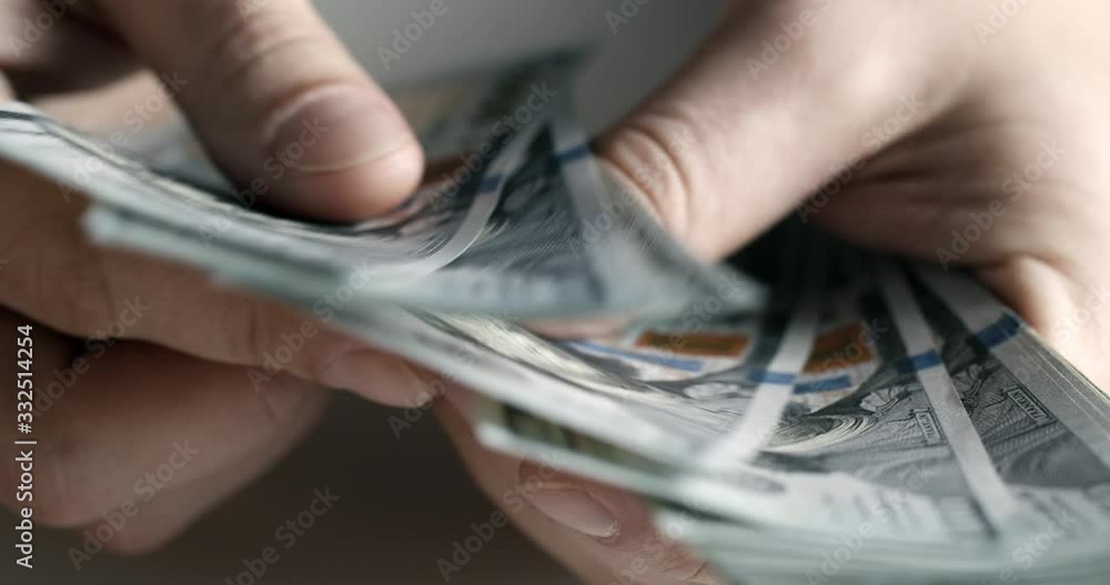 Male employee counting dollar cash salary, hands closeup