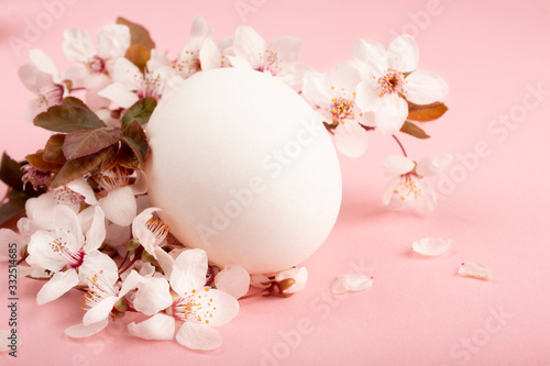 Easter time. Pink and white flowers of the sakura decorate the Easter composition.Easter spring floral pink background. Spring Religious holiday Easter.