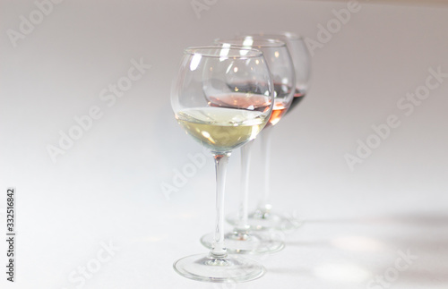 Colorful wine types in glasses on white background