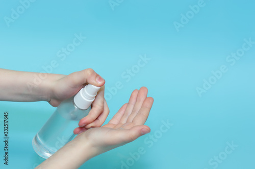 A child sprinkles an antiseptic on his hands. Virus protection. The use of chlorhexidine to protect against viruses and bacteria photo