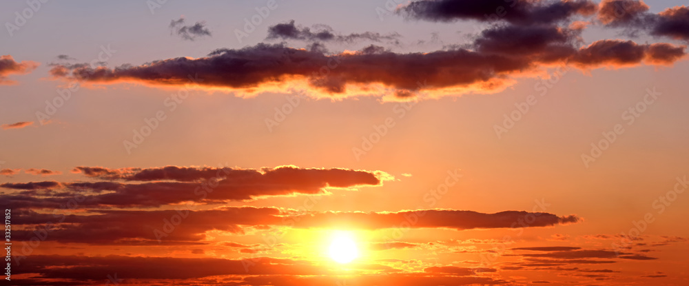 mellow sunset sky landscape background natural color of evening cloudscape panorama with setting sun behind clouds wide panoramic view Red sunlight evening nature