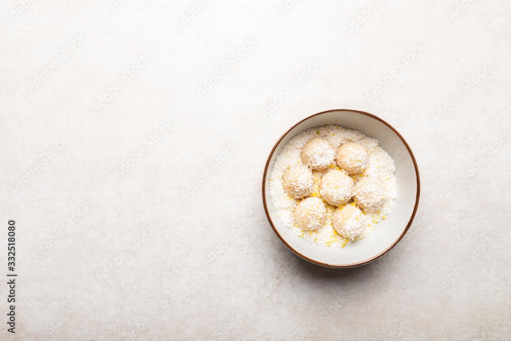 Homemade Raw Vegan Coconut and Lemon Truffles on White Background Homemade Raw Vegan Coconut and Lemon Truffles on White Background