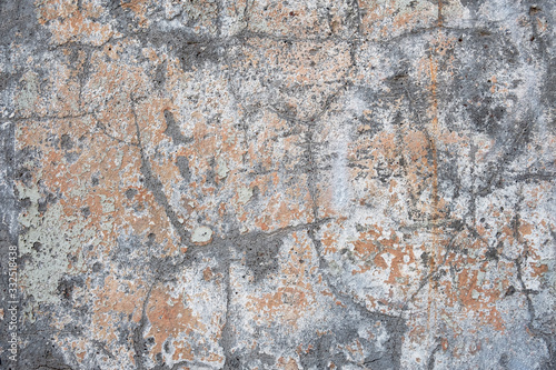 old aged gray concrete wall with white and beige paint stains and scratches. rough surface texture
