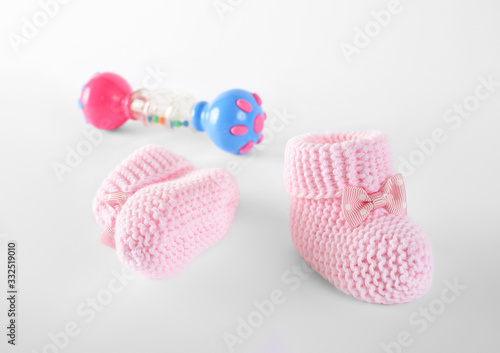 pink baby booties and toy on isolation