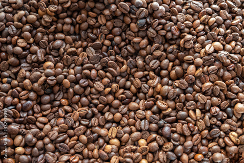 roasted brown coffee beans top view. rough surface texture