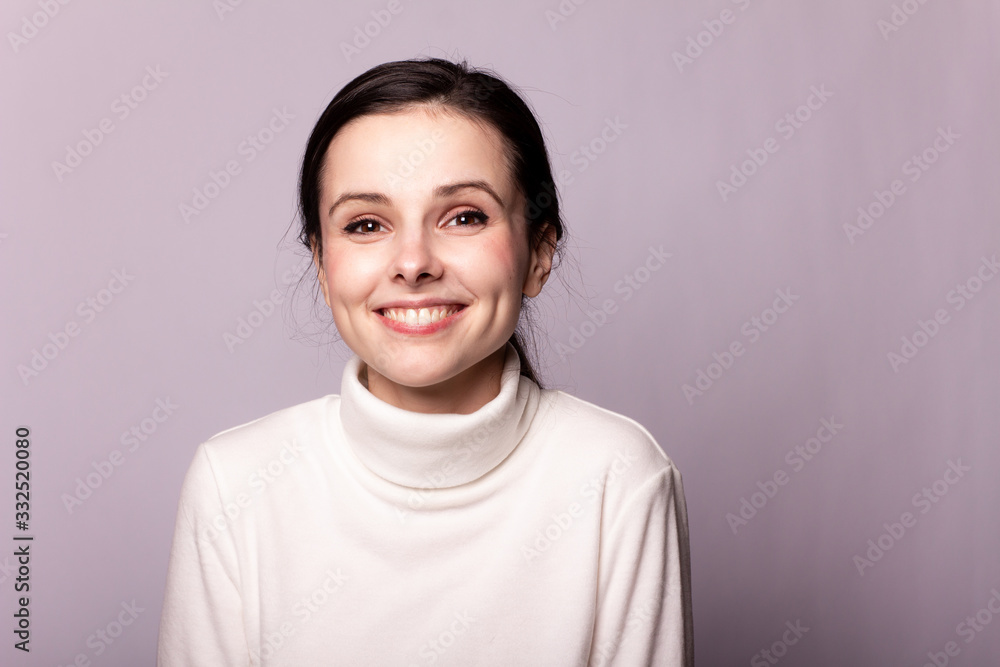 girl in a white turtleneck, portrait on a gray background girl in a white turtleneck, portrait on a gray background