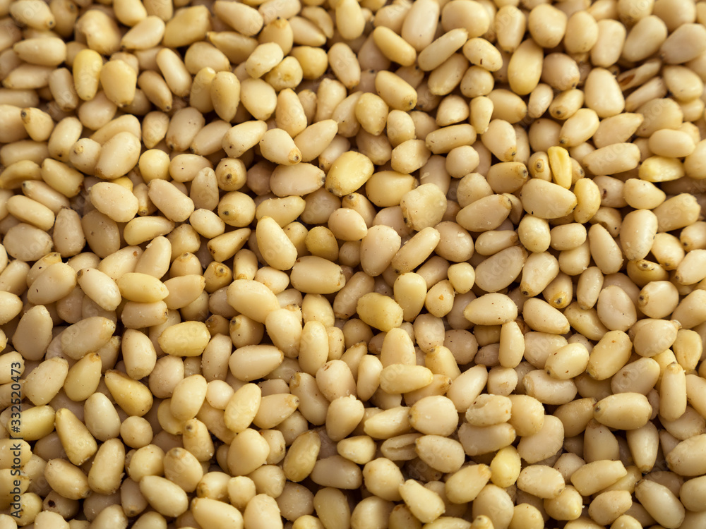 Pine nuts background. Unshelled cedar seeds, closeup Pine nuts background. Unshelled cedar seeds, closeup