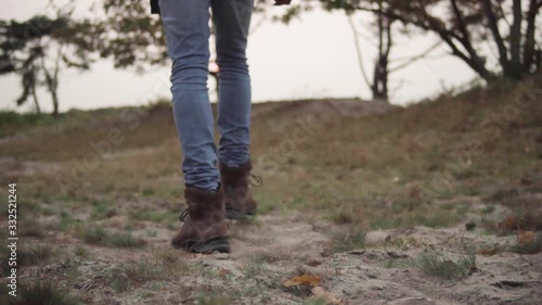 Wallpaper Mural Boots of a young man hiking outdoor trough the sand and grass in slowmotion Torontodigital.ca