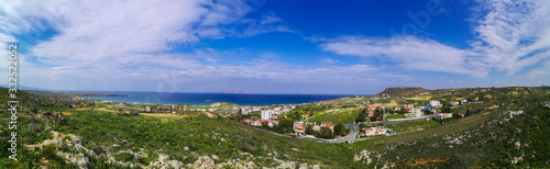 Beautiful Karteros beach. Crete island. Paradise beach with mountains. Travel tourism wide panorama background concept.